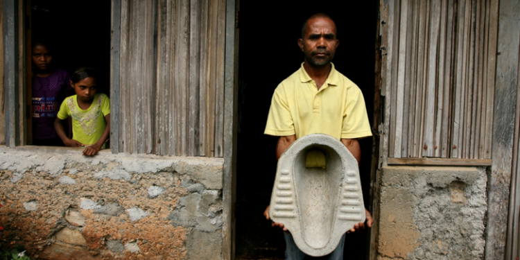 Father and local toilet salesman, Antonia dos Santos in his home village of Lisadila. Antonia creates concrete toilets with the use of a mould and sells them at the market place in Maubara

WaterAid