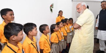 The Prime Minister, Shri Narendra Modi interacting with the school children, at the inauguration of the Integrated Command & Control Centre, at Naya Raipur, Chhattisgarh on June 14, 2018.
	The Chief Minister of Chhattisgarh, Dr. Raman Singh is also seen.