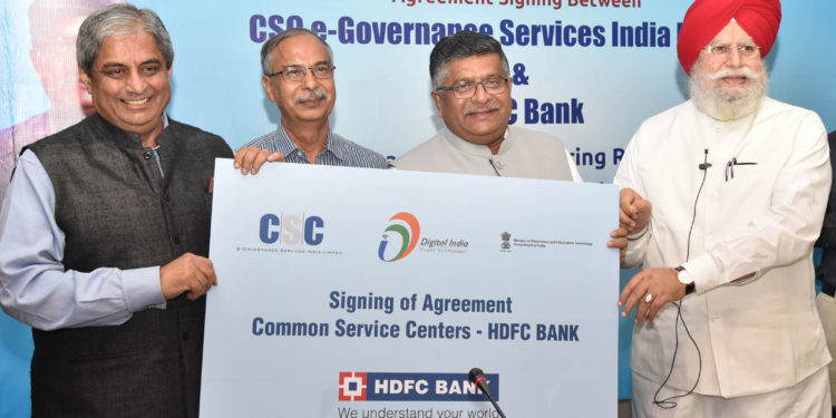 The Union Minister for Electronics & Information Technology and Law & Justice, Mr.Ravi Shankar Prasad and the Minister of State for Electronics & Information Technology, Mr.S.S. Ahluwalia at the signing ceremony of the agreement between HDFC and CSC e-Governance Service India Limited for enabling CSC VLEs all over the country to work as Banking Correspondents, in New Delhi on July 04, 2018.
