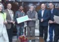The Minister of State for Labour and Employment (I/C), Santosh Kumar Gangwar honouring  Siddhu Siddrameshwar Humanabade who saved 10 lives in fire accident which broke out in Kamgar ESI Hospital, Mumbai, in New Delhi on December 31, 2018. The Secretary, Ministry of Labour and Employment,Heeralal Samariya is also seen.