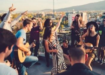 Young people enjoying a music band on a party