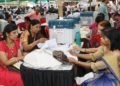Polling officials collecting the Electronic Voting Machine (EVMs) and other necessary inputs required for the General Elections-2019, at the distribution centre, in Indore, Madhya Pradesh on May 18, 2019.