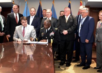 Defense Logistics Agency Director Army Lt. Gen. Darrell Williams (seated, right) signs an interagency agreement between DLA and the Department of Veterans Affairs with VA Secretary Robert Wilkie (seated, left) at the VA Headquarters in Washington, D.C., Aug. 12.