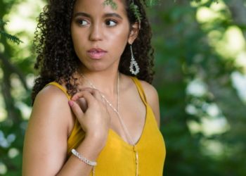 Model wearing clear pieces of jewelry.