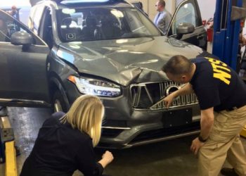 NTSB investigators on-scene in Tempe, Arizona, examining the Uber automated test vehicle involved in the collision.
(NTSB photo)