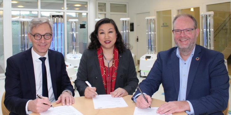 The agreement between UVD Robots and Sunay Healthcare Supply was signed Wednesday, February 19, at UVD Robots’ headquarters in Odense, Denmark by (from left) Per Juul Nielsen, Chief Executive Officer, UVD Robots ApS, Su Yan, Chief Executive Officer, Sunay Healthcare Supply, and Claus Risager, Chairman of the Board, UVD Robots ApS. The reseller agreement grants Sunay Healthcare Supply exclusive rights to supply the UVD robots (visible in background) in China. (Photo: Business Wire)