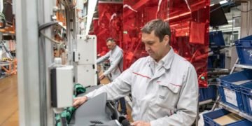 Audi production gradually restarts in EuropeKeep a distance: Red-colored foils for safety.