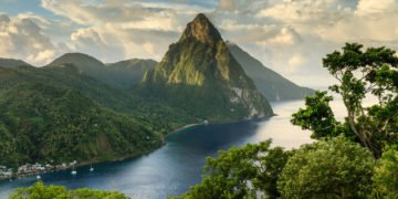 Stunning view of the Pitons (Petit Piton & Gros Piton) from an elevated viewpoint with the rainforest and bay of Soufri?re in the foreground.