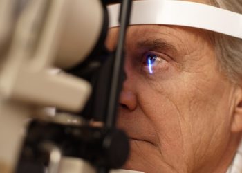 Senior man having eye exam --- Image by © Ocean/Corbis