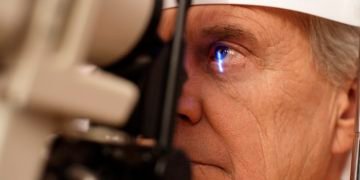 Senior man having eye exam --- Image by © Ocean/Corbis