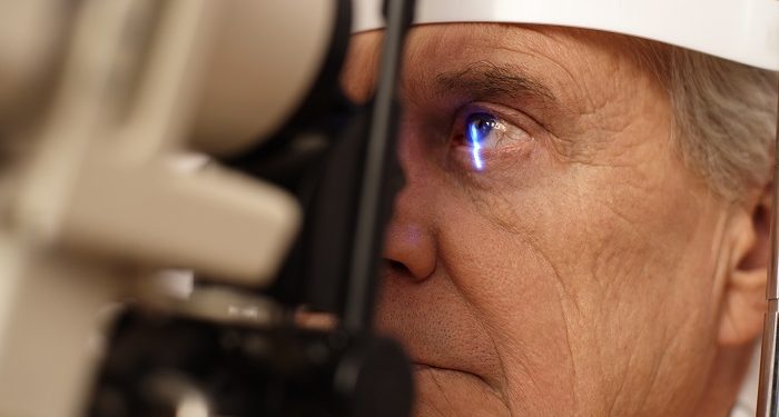 Senior man having eye exam --- Image by © Ocean/Corbis