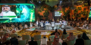 A plenary session at FII6
