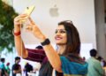 A customer tests out the camera on the yellow iPhone 14 at Apple BKC.