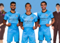 Mumbai City FC players Brandon Fernandes, Lallianzuala Chhangte and Vikram Partap Singh pose in the new jersey with the Etihad Airways logo