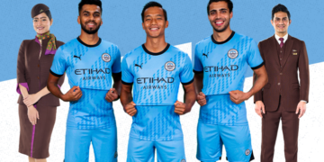 Mumbai City FC players Brandon Fernandes, Lallianzuala Chhangte and Vikram Partap Singh pose in the new jersey with the Etihad Airways logo